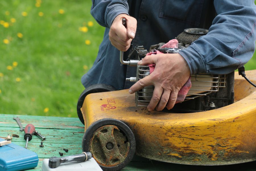Handy man fixing lawn mower